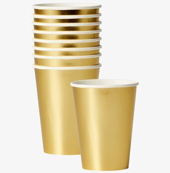 Pappersmuggar Guld från Rice staplade i ett set om tio