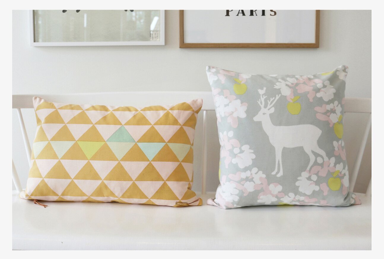 Kuddfodral Vincent Orange från Majvillan på vit bänk