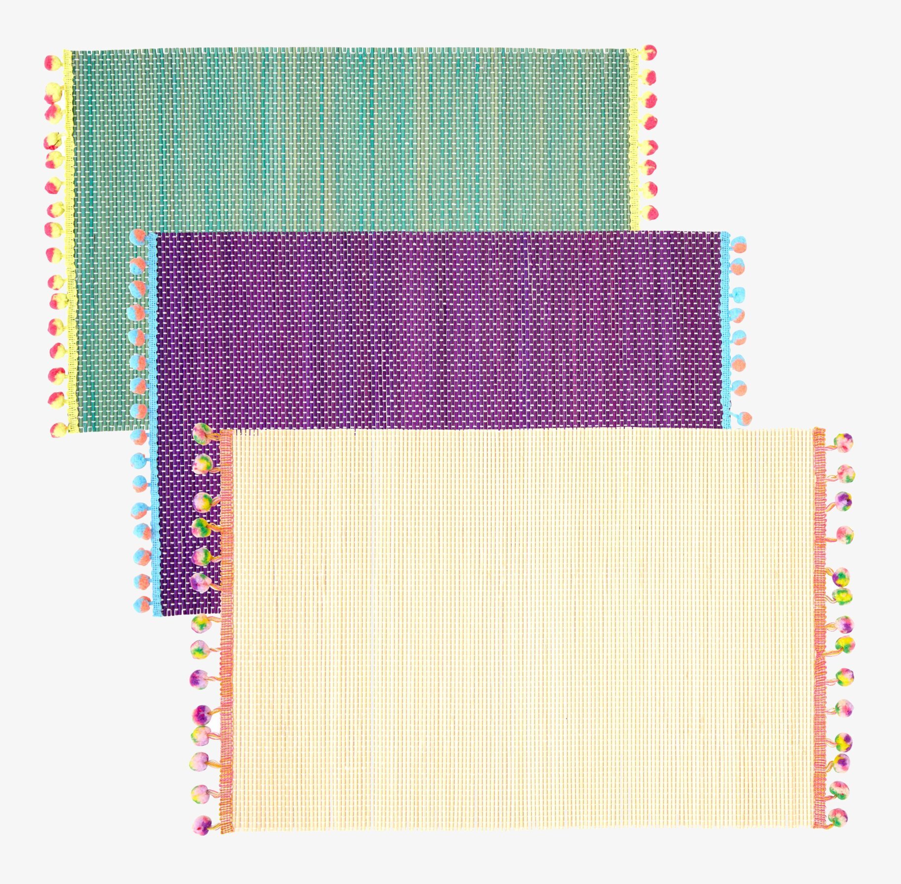 Bordsunderlägg Pom Pom från Rice i tre färgglada varianter