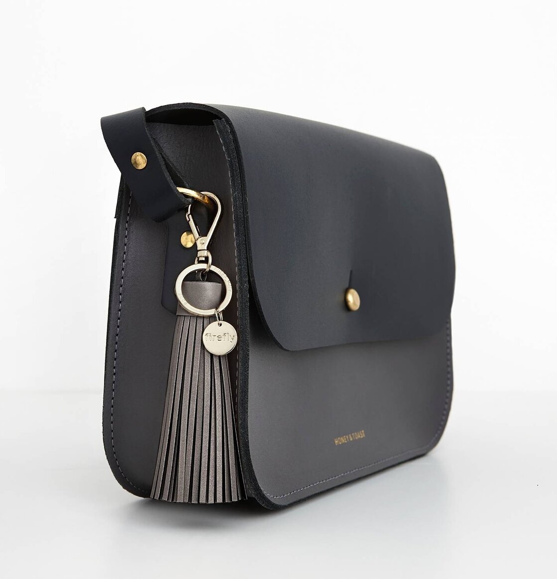 Firefly Mjuk Reflextofs Charcoal med metallklämma och logotyp