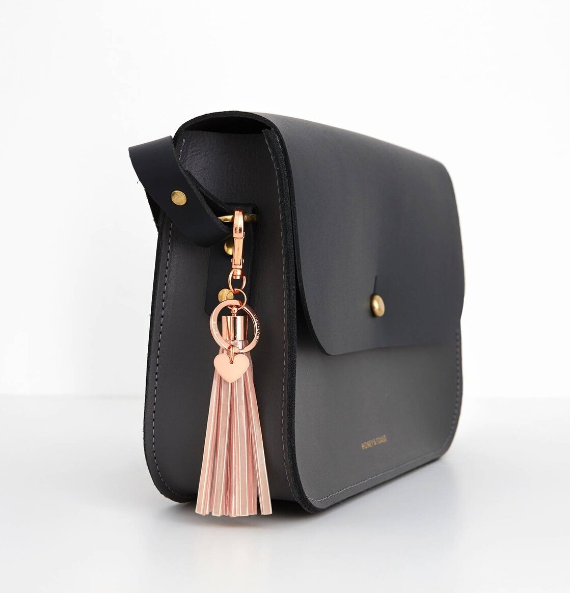 Reflextofs Nude Deluxe Rose Gold från Firefly på svart väska