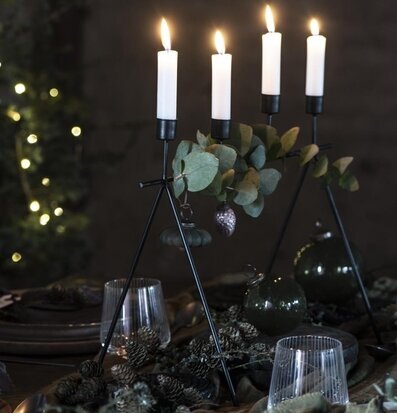 Ljusstake Svart från IB Laursen med vita ljus och gröna blad