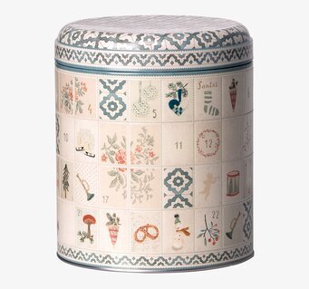 Bild av dekorativ plåtburk med julmotiv och detaljer