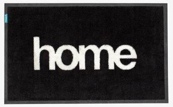 Dörrmatta Home från Dixie med svart bakgrund och vit text