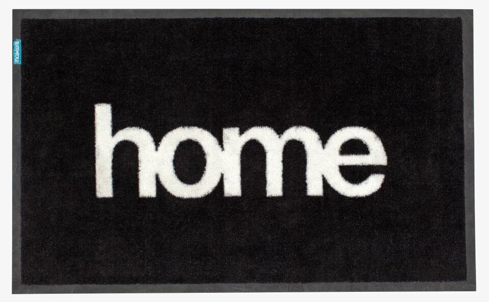 Dörrmatta Home från Dixie med svart bakgrund och vit text