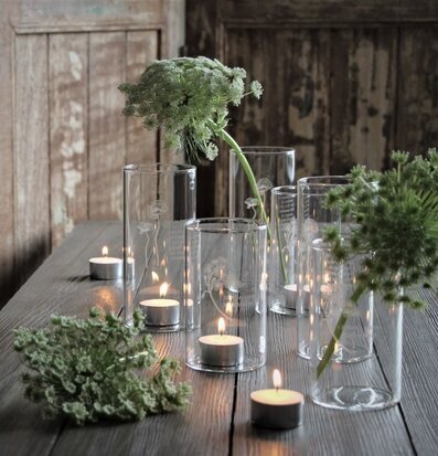 Foto av stämningsfull scen med ljuslyktor och växter