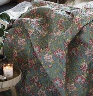 Pläd Petrol Blomster från IB Laursen på soffa i mysigt rum