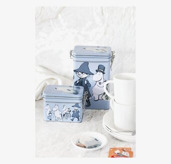 Foto av eleganta teburkar med Muminmotiv och porslin