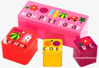 Bild av färgglada plåtburkar med lekfulla motiv