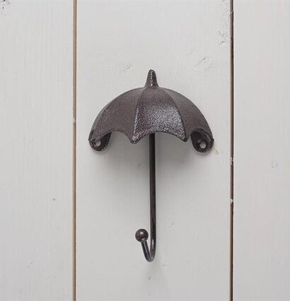 Krok Paraply från Multi Agentur monterad på vit trävägg