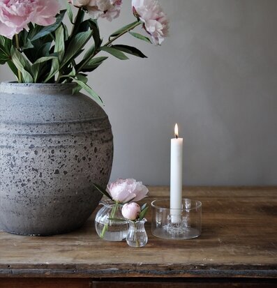 Bild av stämningsfull interiör med pioner och ljus