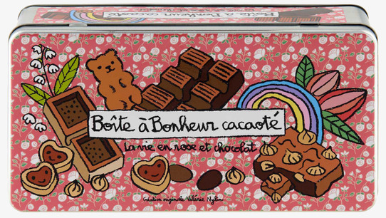 Bild av dekorativ rosa plåtburk med chokladmotiv