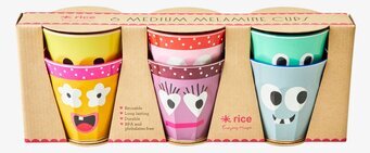 Bild av färgglada muggar med lekfulla ansiktsmotiv