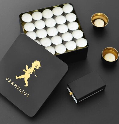 Bild av stilfulla värmeljus i svart och guld design