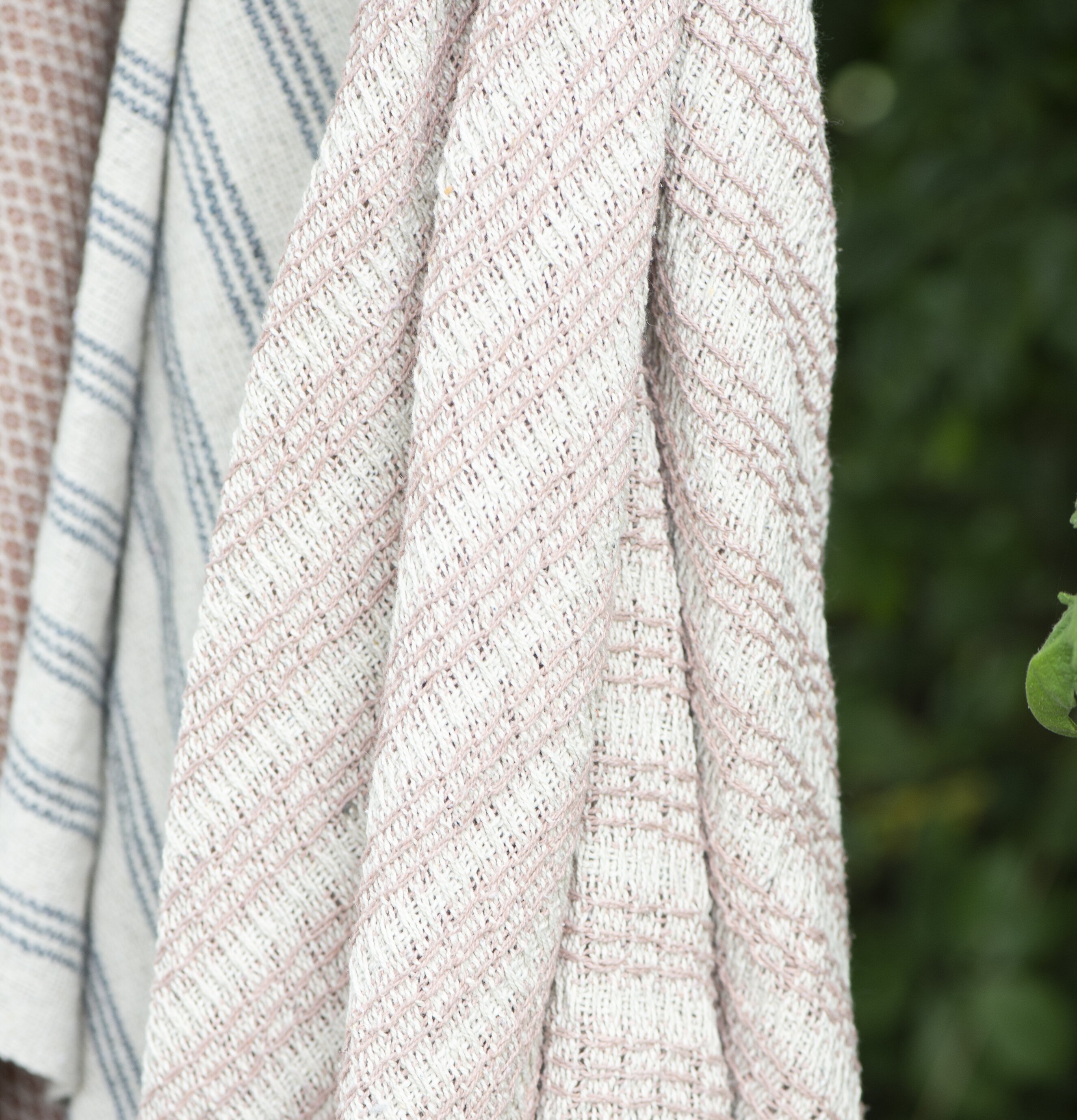 Pläd Creme/Malva från IB Laursen i en grönskande miljö