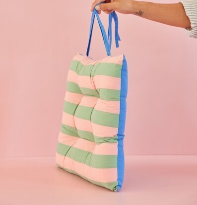 Stolsdyna Striped Print Pink/Green från Rice hålls upp av hand