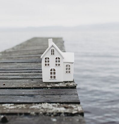 Bild av ljusstake vid sjö på träbrygga i nordisk stil