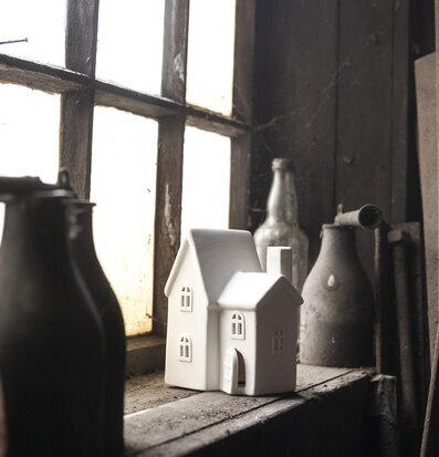 Foto av fönsterbräda med ljusstake och glasflaskor