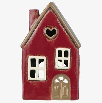 Foto av charmig röd ljuslykta i husform med hjärtöppning