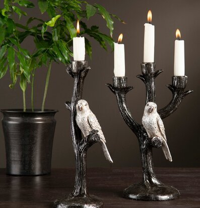 Ljusstake Papegoja från A Lot Decoration på träyta med växt