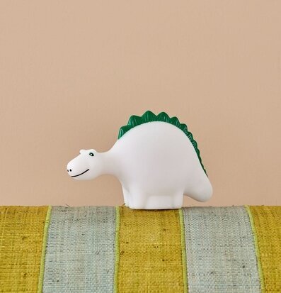 Lampa LED Dino från Rice på randig struktur med beige vägg