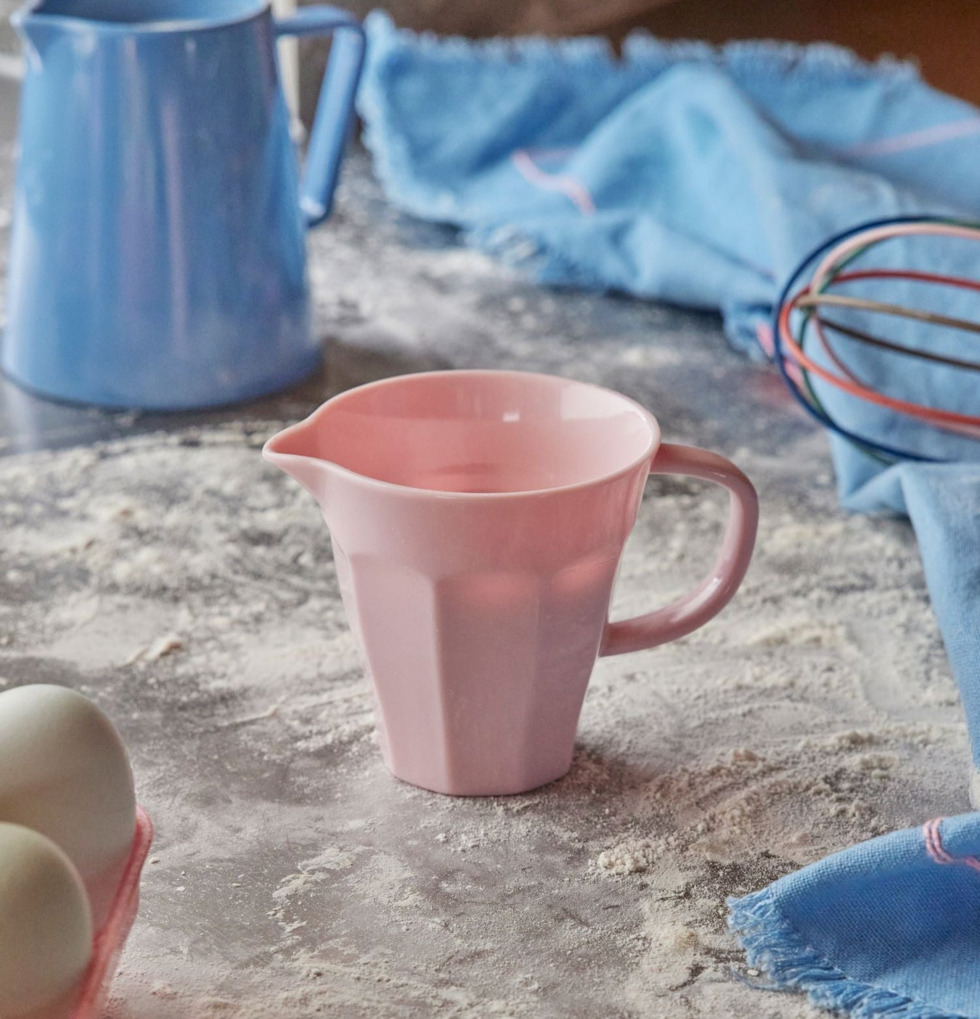 Mjölkkanna Melamin Rosa från Rice på en mjölig köksbänk