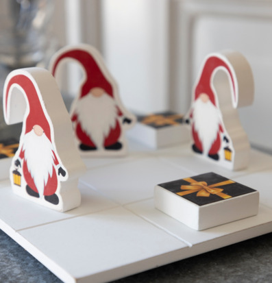 Tre i rad Tomte/Paket från Different Design på ett bord