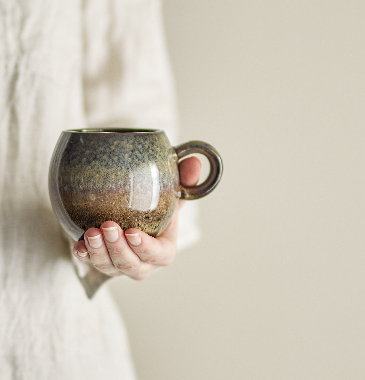 Mugg Stengods Brun från Bloomingville, hålls av en person