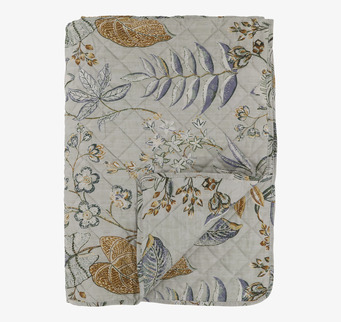 Bild av en quilt med blommönster och subtila nyanser