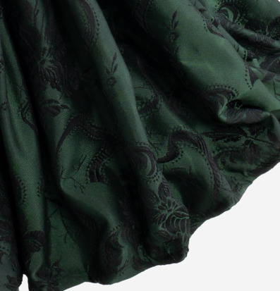 Bild av detaljrik grön textil med eleganta mönster