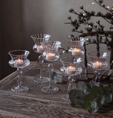 Bild av glaslyktor på träbord med stämningsfull belysning