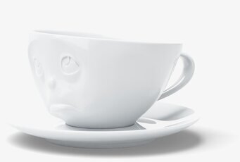 Foto av unik kaffekopp med ansikte och fat i porslin