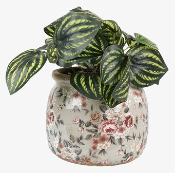 Foto av smakfull kruka med blommönster och gröna blad