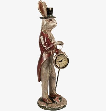 Bild av dekorativ kaninfigur med klocka och blommor