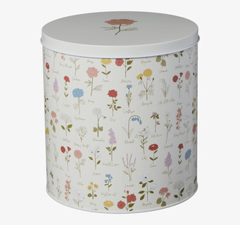 Bild av rund plåtburk med blommönster och offwhite färg