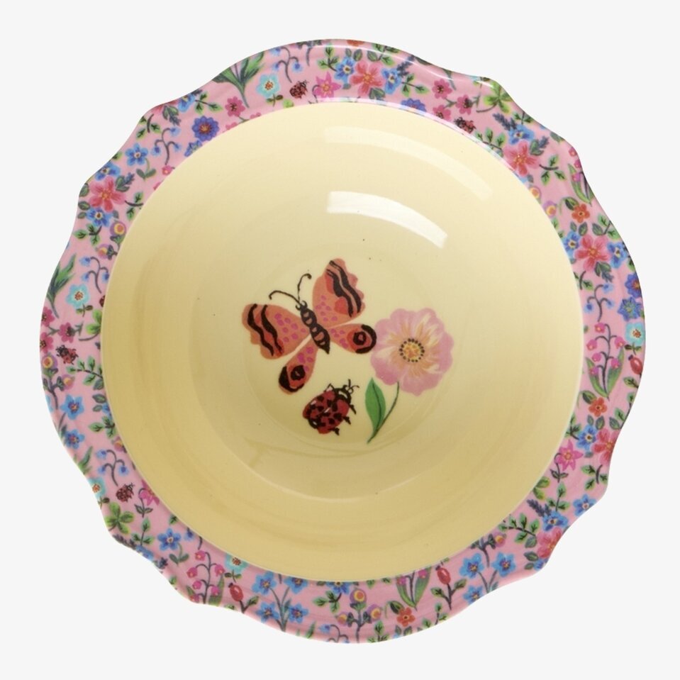 Bild av färgglad skål med blommor och fjärilsmotiv