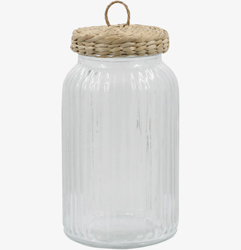 Foto av stor glasburk med flätat lock och räfflad yta