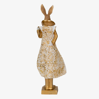 Bild av elegant gyllene kaninfigur med detaljerad klänning
