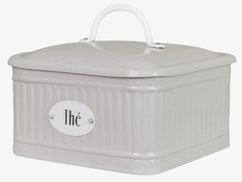 Bild av beige plåtburk med textur och te-förvaring