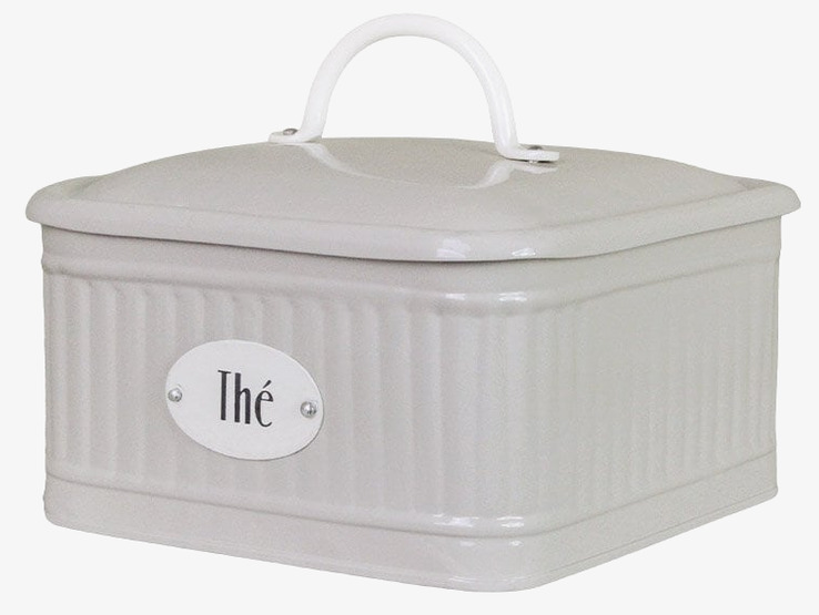 Bild av beige plåtburk med textur och te-förvaring