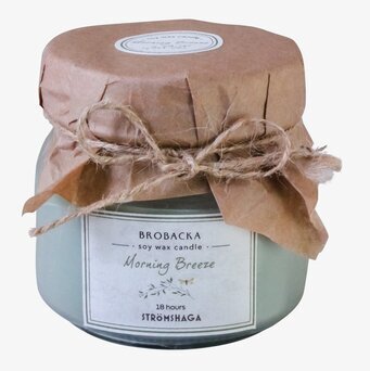 Bild av ett elegant doftljus i glas med rustika detaljer