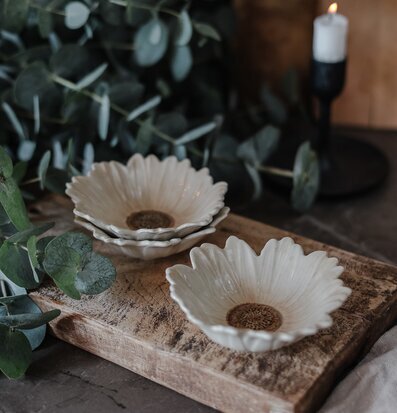 Bild av blomformade skålar på rustik träskiva