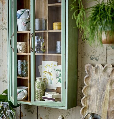 Bild av hemtrevlig inredning med grönt väggskåp