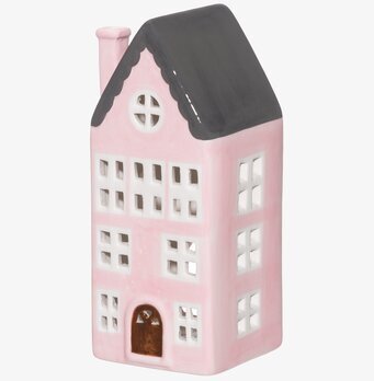 Foto av ljuslykta i form av ett stiliserat rosa hus