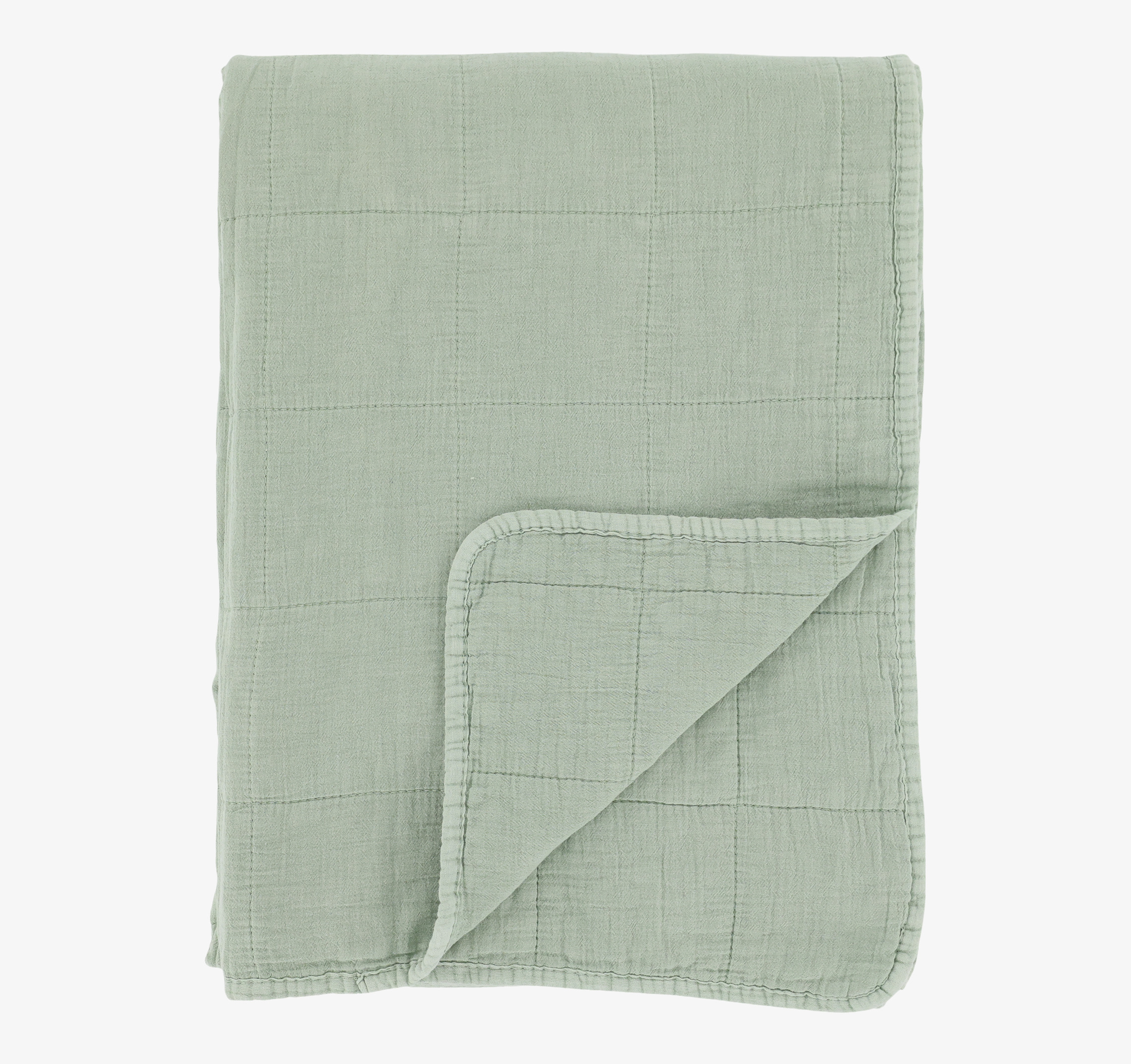Bild av quiltad pläd i dämpad grön färg och elegant design