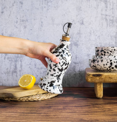 Bild av rustikt kök med svartvit olivoljeflaska och skålar