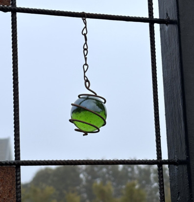 Bild på grön glaskula i metallnät – inspiration för inredning