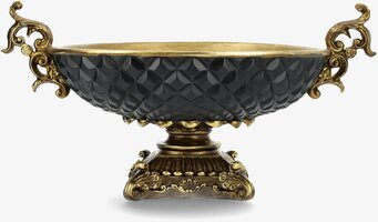 Bild på dekorativ skål med guld och svart fasetterat mönster