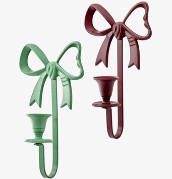 Bild på två väggljusstakar i rosettform i grönt och vinrött