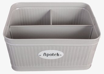 Bild på beige rektangulär plåtburk med fyra fack och skylt